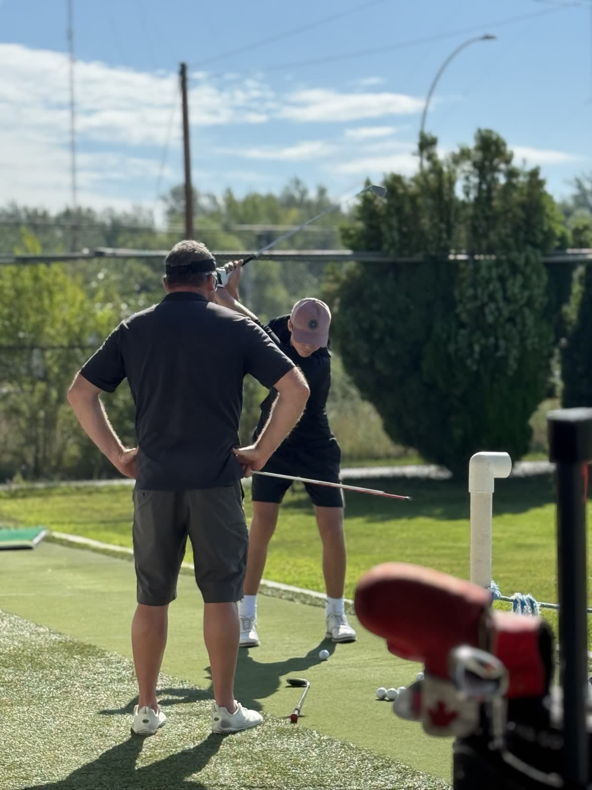 PGA of Canada coach Steve Lawrence watching a student's backswing during a lesson at Kelowna Driving Range